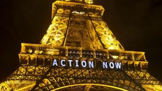 The Eiffel Tower lights up with the slogan"Action Now"referring to the COP21, United Nations Climate Change Conference in Paris, Sunday, Dec. 6, 2015. Negotiators adopted a draft climate agreement Saturday that was cluttered with brackets and competing options, leaving ministers with the job of untangling key sticking points in what is envisioned to become a lasting, universal pact to fight global warming. (AP Photo/Michel Euler)