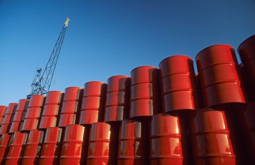 Red metal barrels against blue sky.