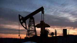 Beautiful sunset over oil field with pump jack